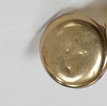 An Italian 750 yellow metal and two stone blue cabochon set articulated gold fish pendant, overall 46mm and a yellow metal and split pearl set circular locket. Condition - poor to fair